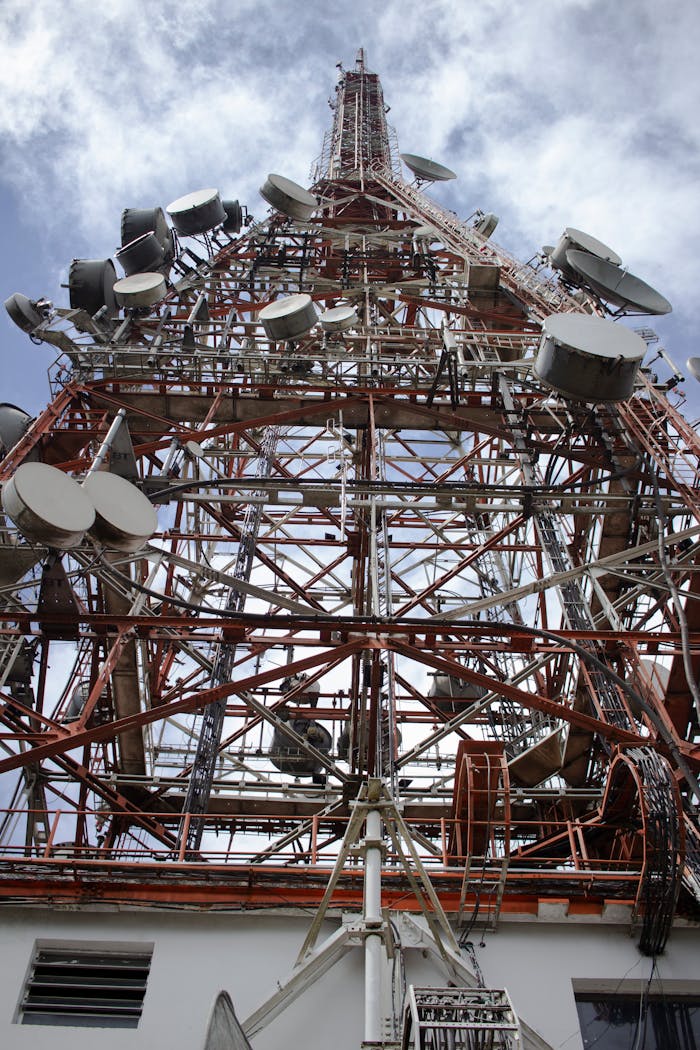 creative Close-up of a telecommunication tower in São Paulo, highlighting its metal structure and satellite dishes.