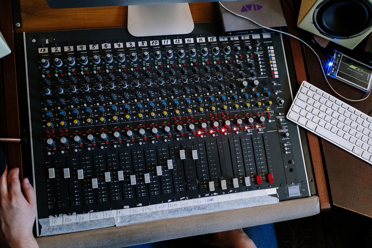 mobile-01 Close-up of audio mixing console in use at a recording studio.